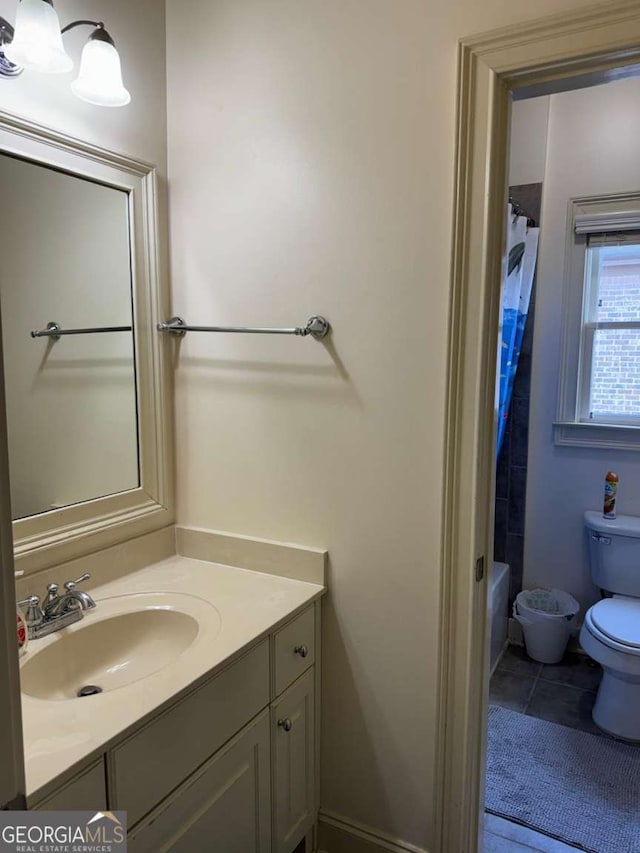 full bath featuring vanity, tile patterned flooring, and toilet