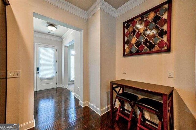 entrance foyer featuring crown molding and dark wood-type flooring