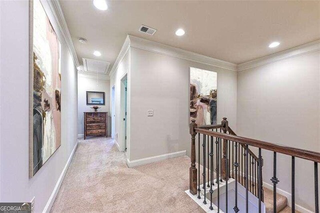 hallway featuring light carpet and crown molding