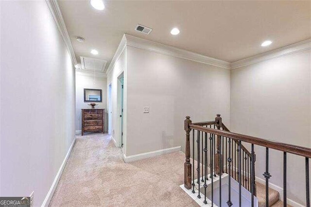 hall featuring light carpet and ornamental molding