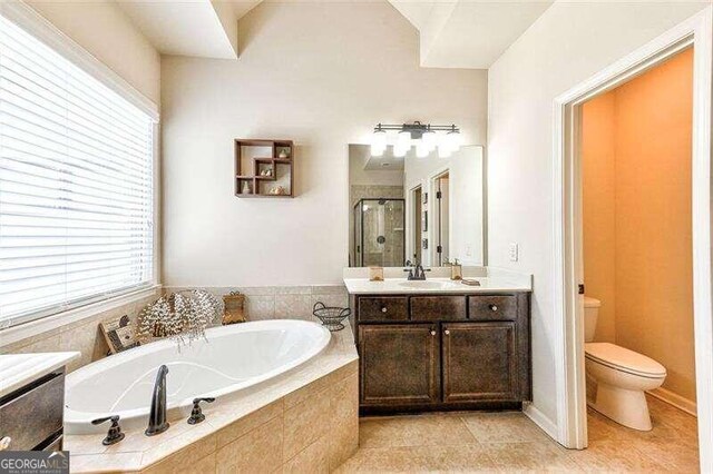 full bathroom featuring vanity, tile patterned flooring, toilet, and plus walk in shower