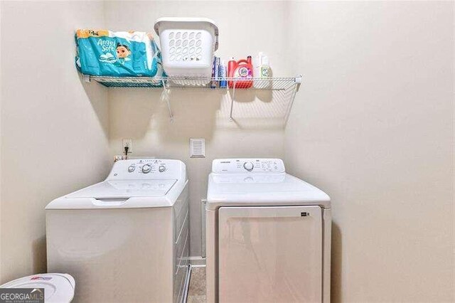 clothes washing area featuring washing machine and clothes dryer