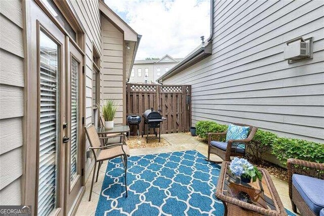 view of patio with a wall unit AC