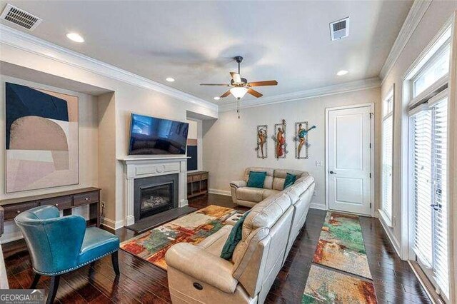 living room featuring ornamental molding, dark hardwood / wood-style flooring, and ceiling fan