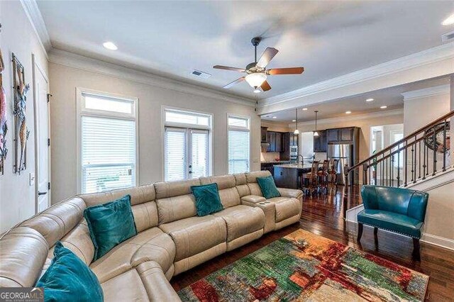 living room featuring crown molding, ceiling fan, and dark hardwood / wood-style flooring