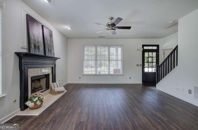 unfurnished living room featuring ceiling fan and dark hardwood / wood-style floors