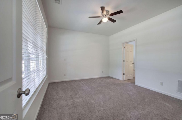 unfurnished room featuring light carpet and ceiling fan