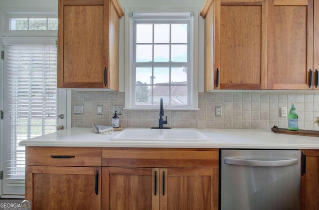 kitchen with sink, plenty of natural light, decorative backsplash, and stainless steel dishwasher