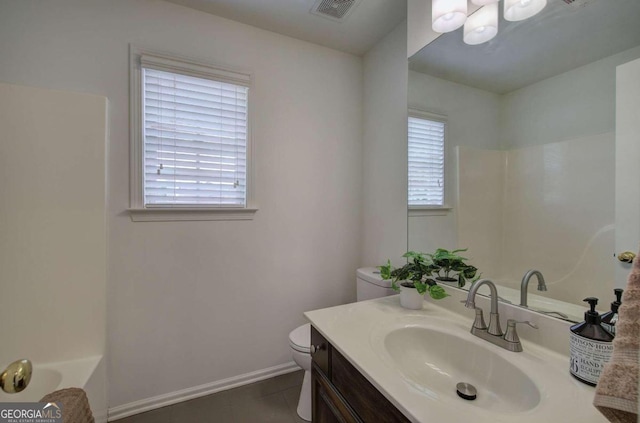 bathroom with vanity, a bathtub, tile patterned flooring, and toilet