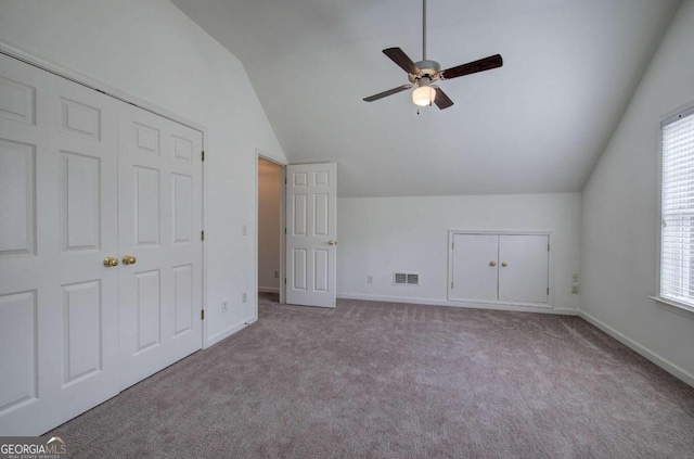 additional living space featuring lofted ceiling, plenty of natural light, and light carpet