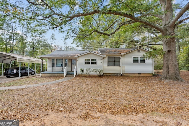 ranch-style home featuring a carport and a porch