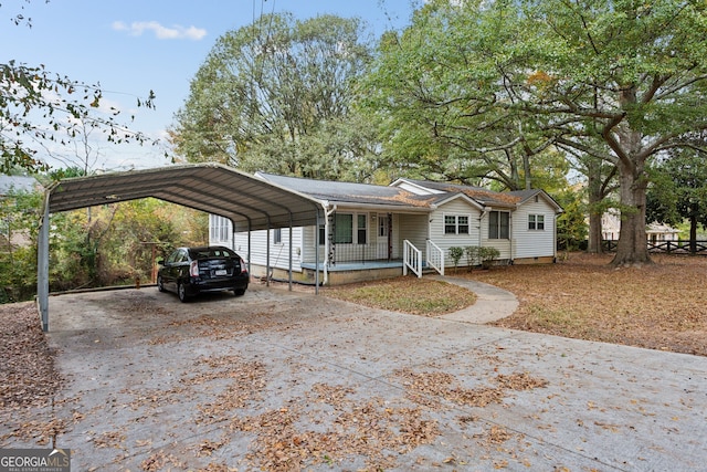 view of front of house with covered porch and a carport