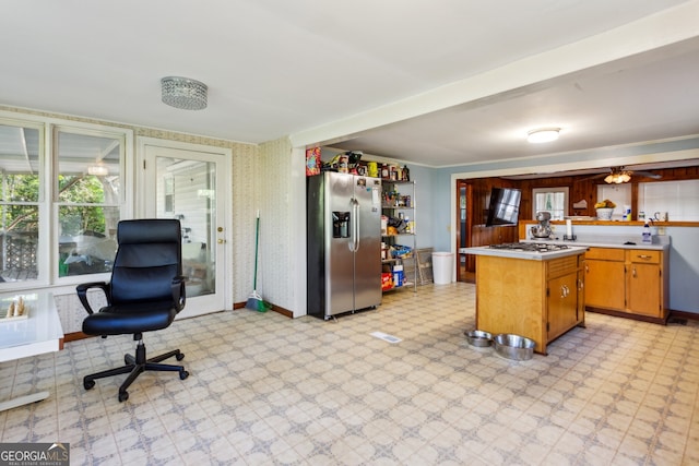 kitchen with kitchen peninsula, ceiling fan, and stainless steel appliances