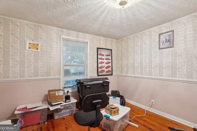 office space featuring a textured ceiling, hardwood / wood-style flooring, and crown molding