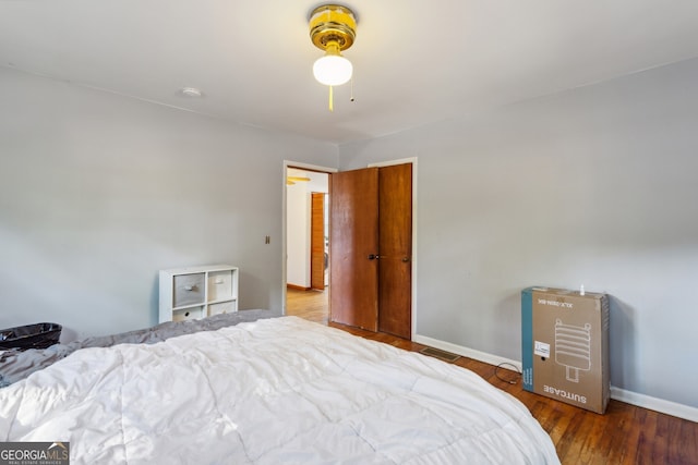 bedroom featuring hardwood / wood-style floors and ceiling fan