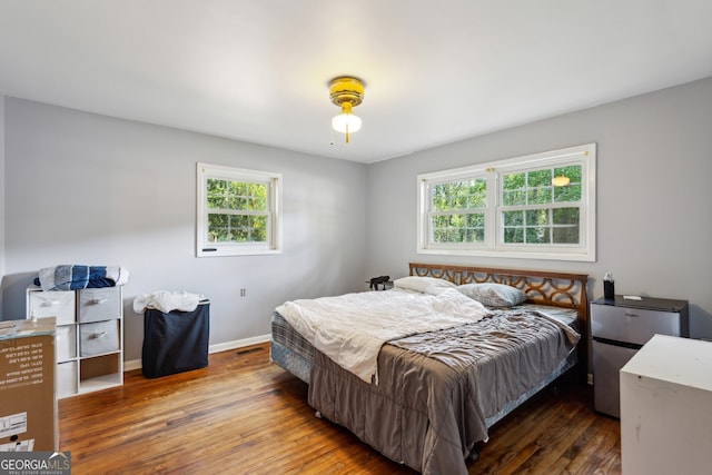 bedroom featuring dark hardwood / wood-style floors and ceiling fan