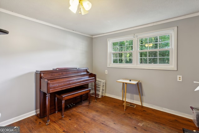 misc room featuring ornamental molding and dark hardwood / wood-style floors