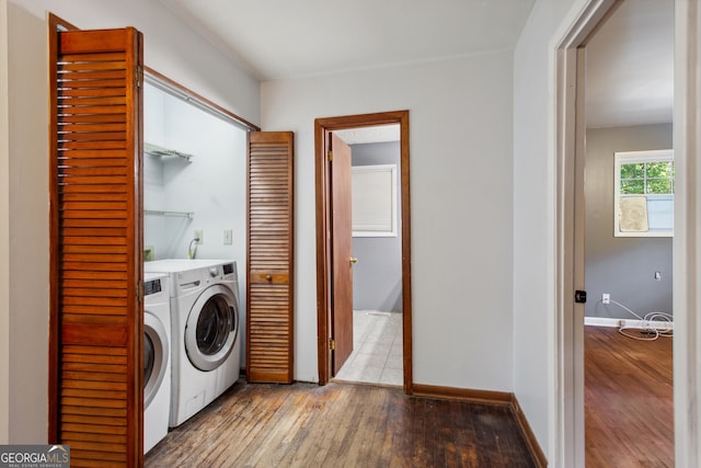 laundry area with light hardwood / wood-style floors and washing machine and dryer