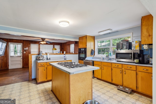 kitchen with a center island, appliances with stainless steel finishes, sink, and plenty of natural light