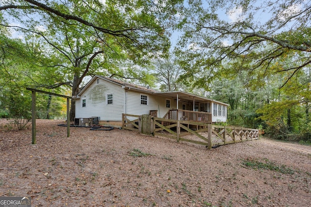 back of property featuring a wooden deck