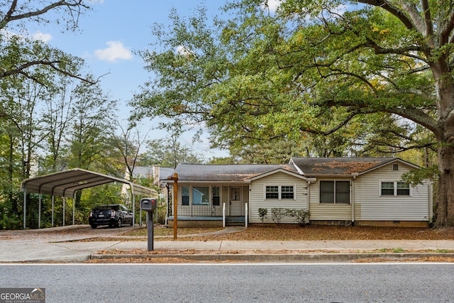 view of front of home with a porch and a carport