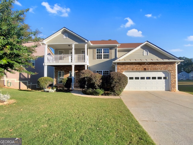 view of front of house featuring a garage, a balcony, and a front lawn