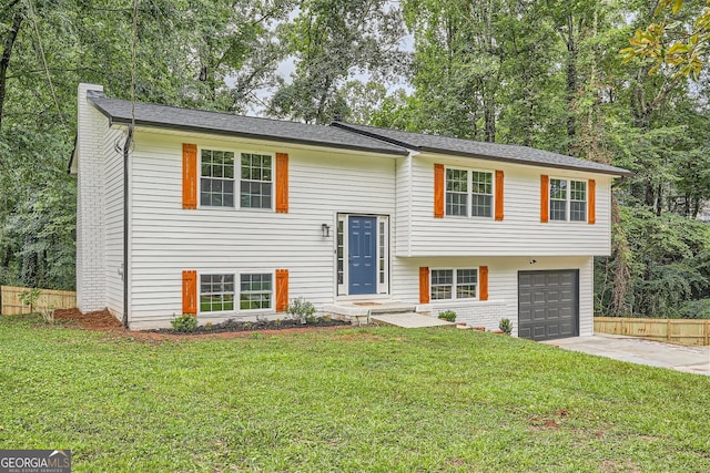 bi-level home featuring a garage and a front yard