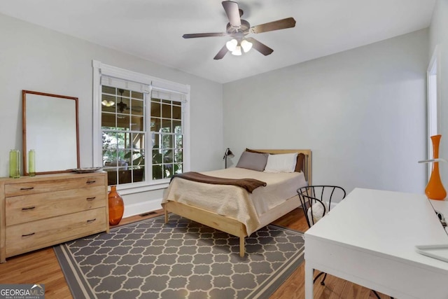 bedroom with ceiling fan and dark hardwood / wood-style flooring