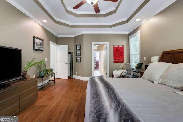 bedroom with dark wood-type flooring, crown molding, ensuite bath, and ceiling fan