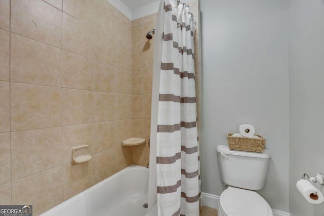 bathroom with shower / bath combo with shower curtain and toilet