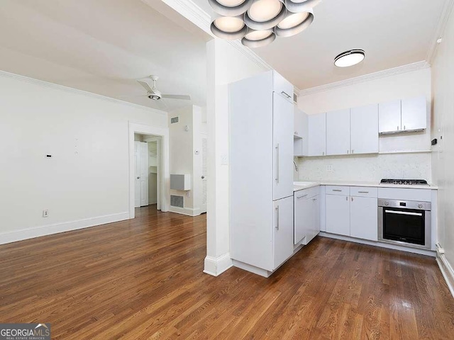 kitchen featuring appliances with stainless steel finishes, ceiling fan, crown molding, white cabinets, and dark hardwood / wood-style floors