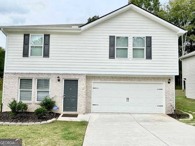 view of front of home with a front yard and a garage