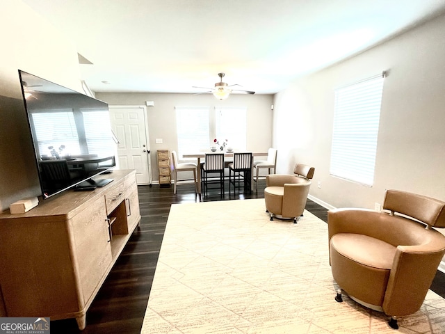 living room with wood-type flooring, ceiling fan, and a healthy amount of sunlight