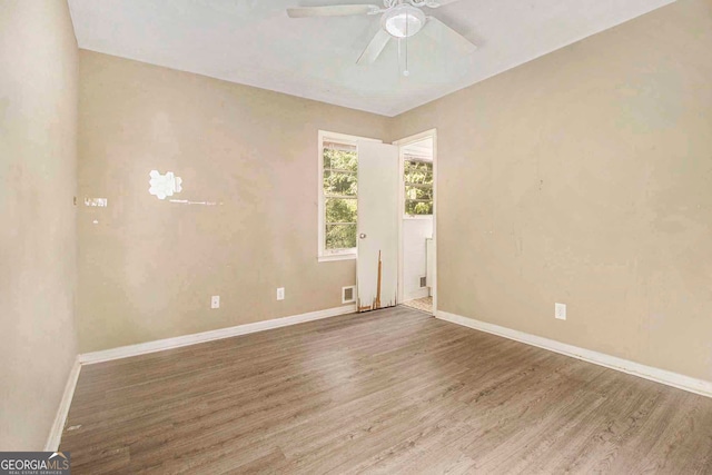 empty room with ceiling fan and hardwood / wood-style floors