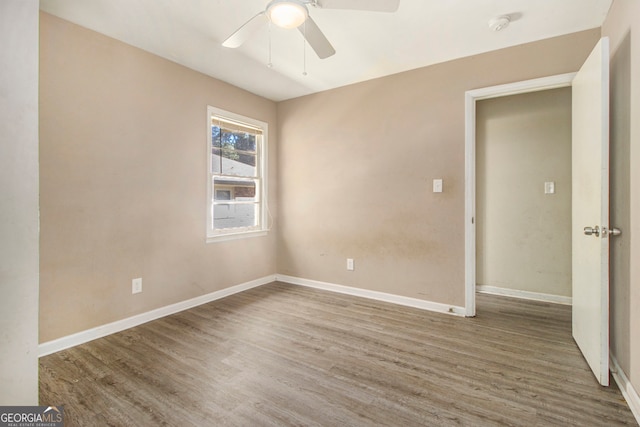 empty room featuring wood-type flooring and ceiling fan