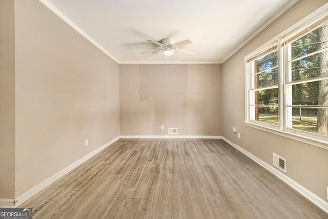 spare room featuring light hardwood / wood-style floors, ornamental molding, and ceiling fan