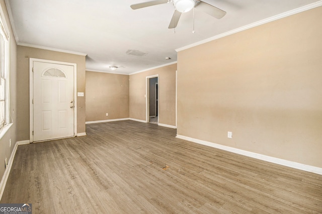 spare room with ornamental molding, hardwood / wood-style flooring, and ceiling fan