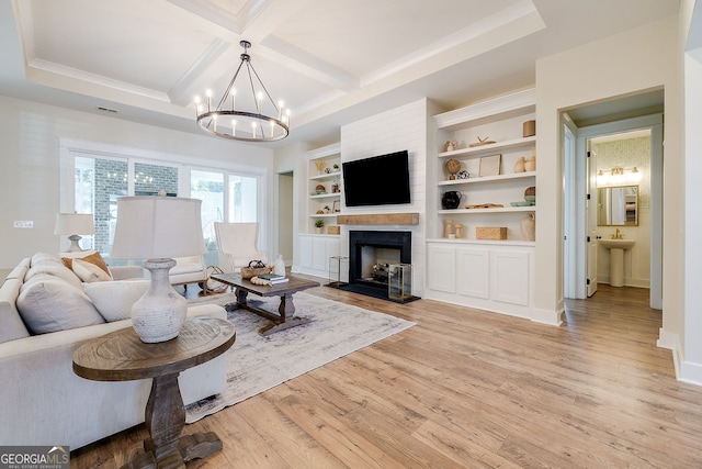 living room with an inviting chandelier, light hardwood / wood-style flooring, beamed ceiling, built in features, and coffered ceiling