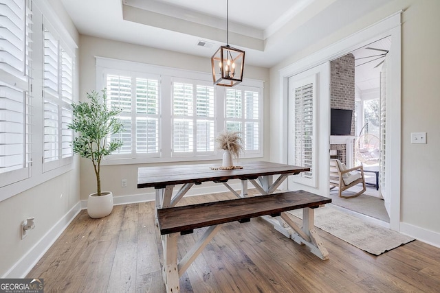 205 Park Chase, Pooler, GA 31322 - dining space with light wood-style floors, a tray ceiling, a chandelier, and baseboards