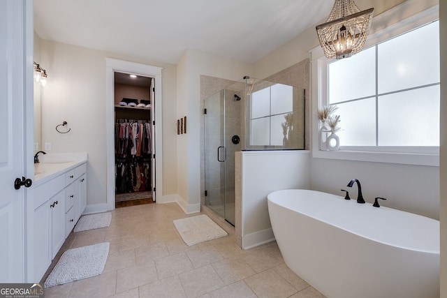 bathroom with vanity, a notable chandelier, independent shower and bath, and tile patterned flooring