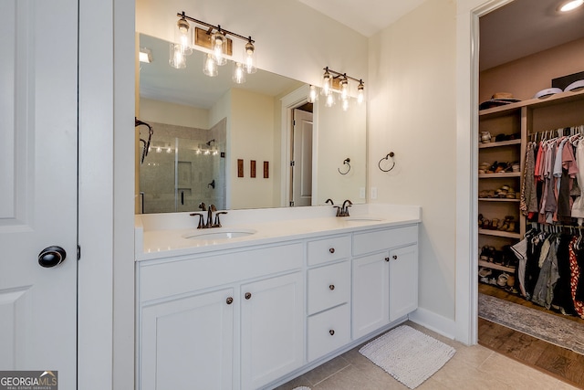 bathroom featuring vanity, hardwood / wood-style flooring, and an enclosed shower