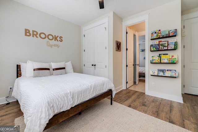 bedroom featuring hardwood / wood-style flooring, a closet, and ceiling fan