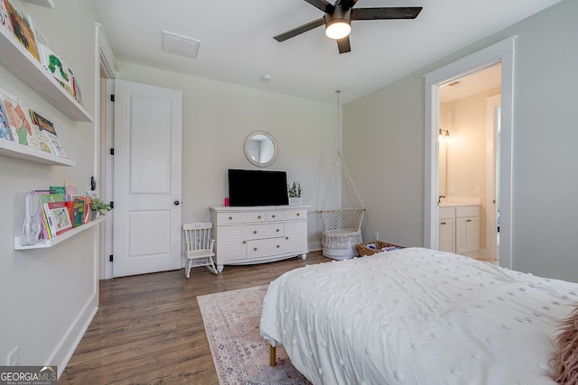 bedroom featuring dark wood-type flooring, ensuite bathroom, and ceiling fan