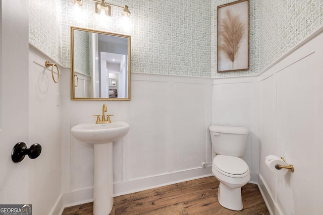 205 Park Chase, Pooler, GA 31322 - half bathroom featuring toilet, a wainscoted wall, wallpapered walls, wood finished floors, and a decorative wall