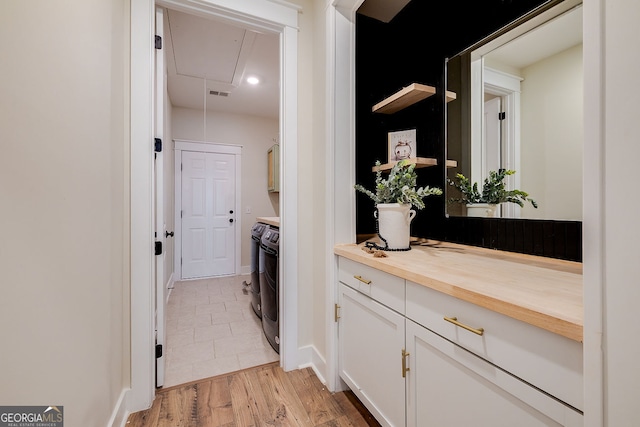 interior space with vanity and wood-type flooring