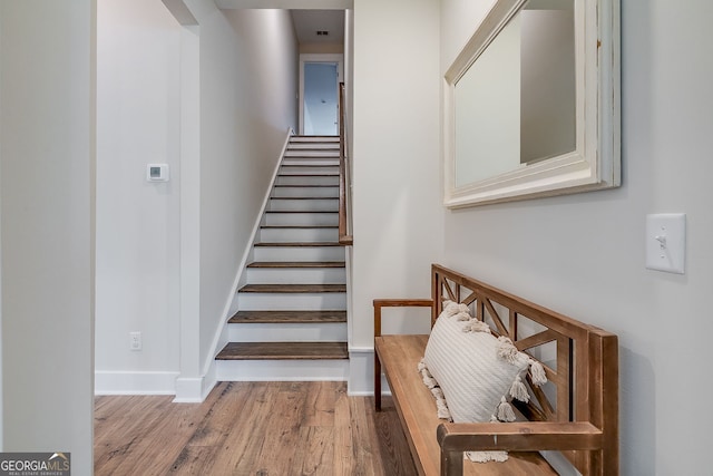 stairs featuring hardwood / wood-style flooring