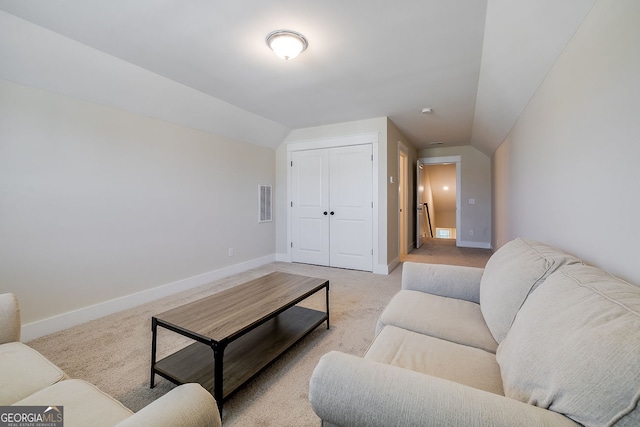 carpeted living room with vaulted ceiling