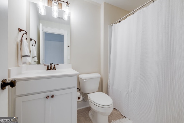 bathroom featuring toilet, vanity, and tile patterned flooring