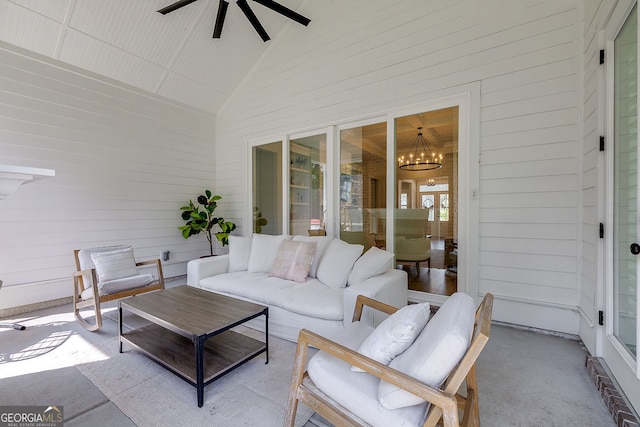 sunroom with vaulted ceiling and ceiling fan with notable chandelier