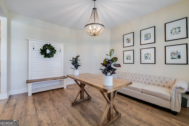 office space featuring hardwood / wood-style flooring and an inviting chandelier